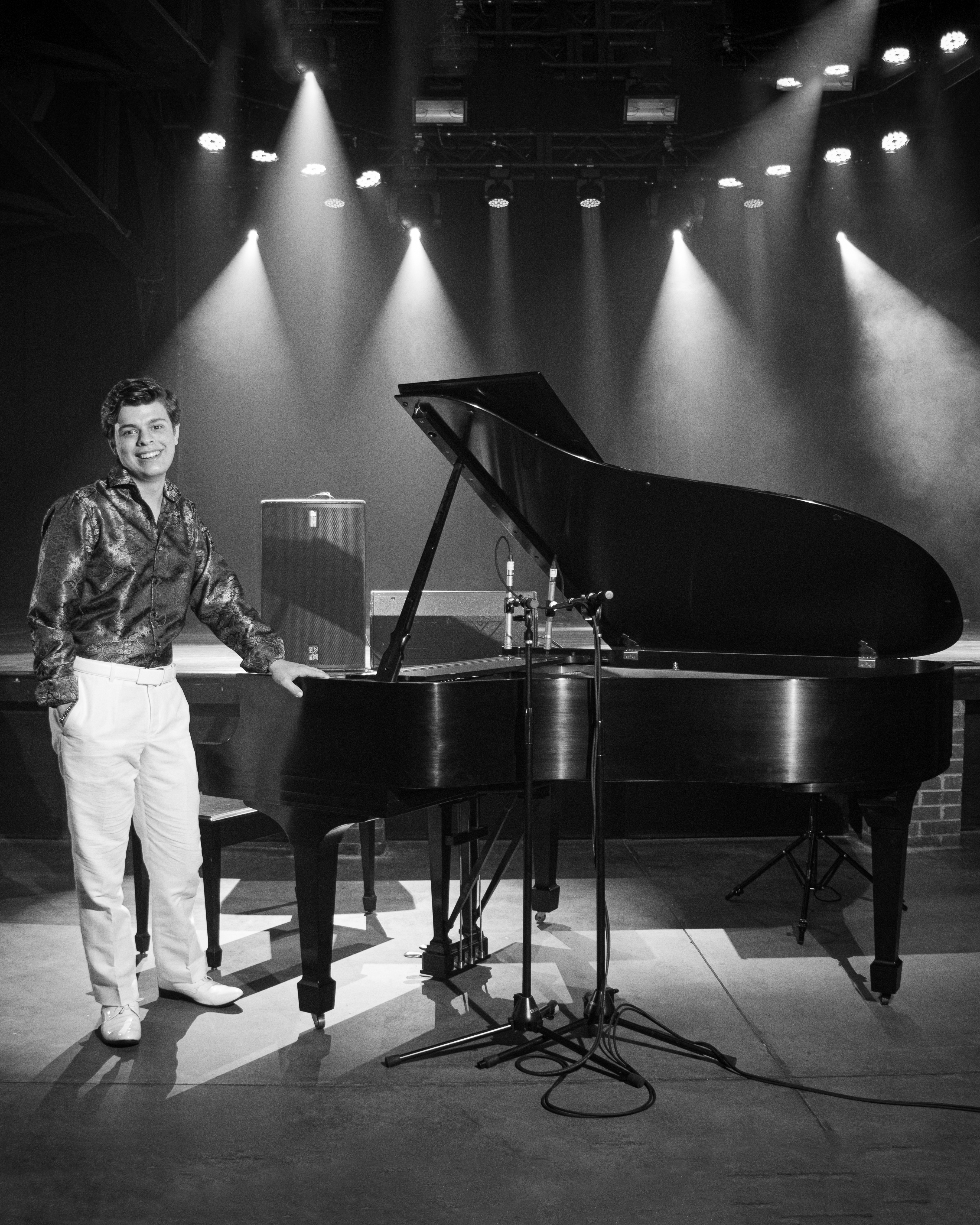 Michael Rainwater pianist performing on stage at grand piano with dramatic lighting